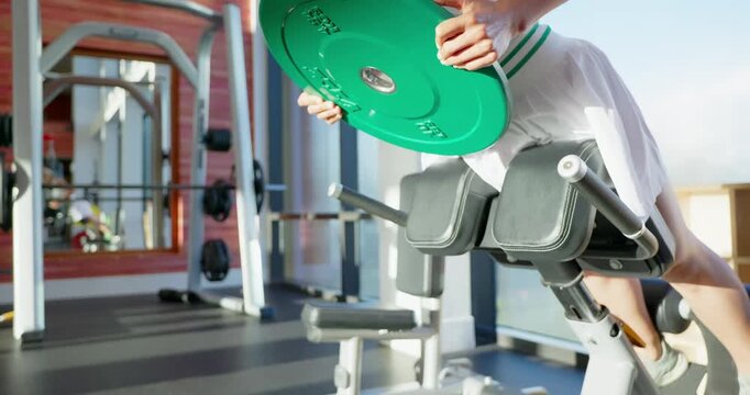 Woman Performing Hyperextension Exercise in Gym