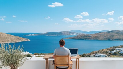 Obraz premium Man focusing on his laptop, working from a terrace with a stunning panoramic view of the sea and islands