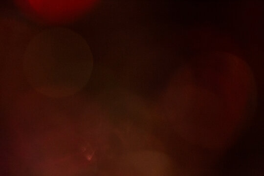 Dark Red and Orange Bokeh Lights with Grain Texture Abstract Background