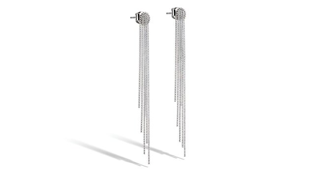 A pair of shiny silver earring drops with intricate details on a white background