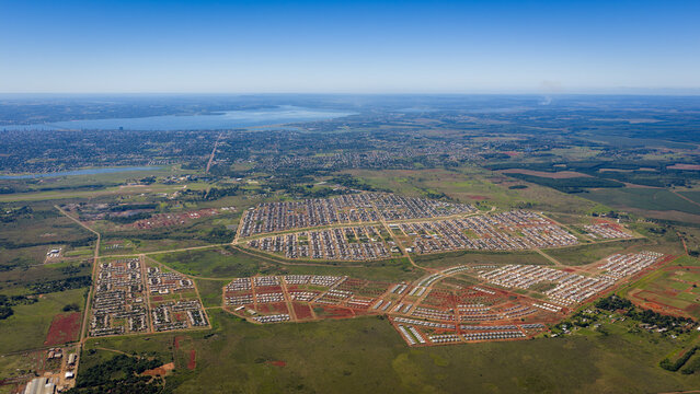 Wide aerial view of Itaemb&eacute; Guaz&uacute; residential development with Posadas city and Paran&aacute; River in the background, Argentina.