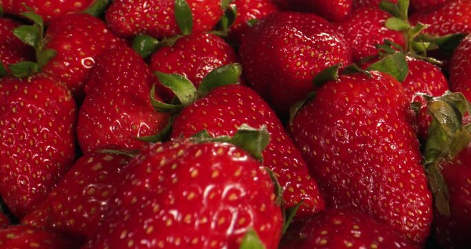 Colorful Market Scene Featuring Overflowing Display Of Luscious Strawberries