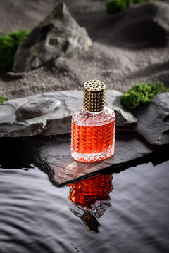 Aromatic red perfume in an oasis on stony black desert.