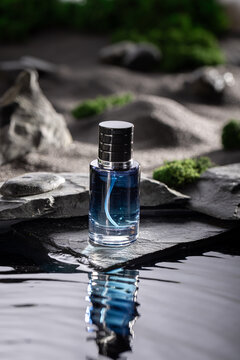 Intense blue perfume on a dark stone by the water.