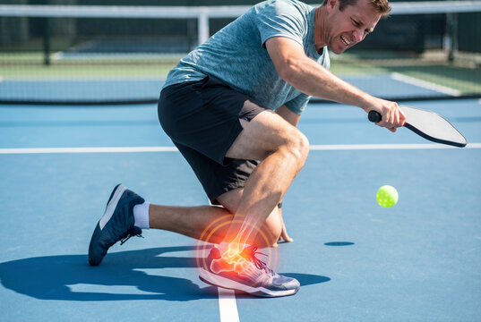 Athletic man suffering from a pickleball ankle sprain court injury during an outdoor game for sports medicine and physiotherapy marketing