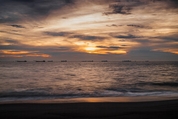 Fototapeta premium golden hour sunset over Melaka or Malacca Straits coastal beach and sea at Pantai Puteri