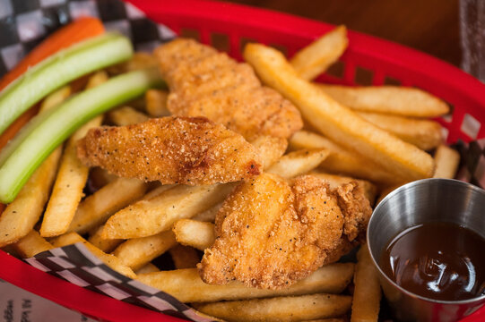Chicken strips and fries at a restaurant as part of the children&rsquo;s meal.