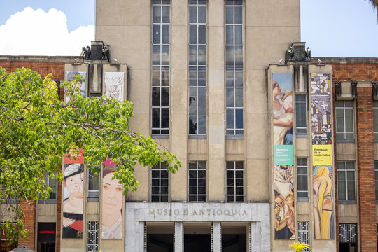 Medellin, colombia april 12, 2026, botero square museo de antioquia building facade with art banners