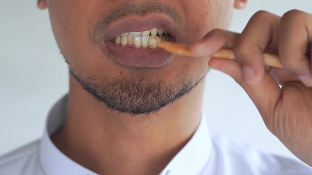 Man using miswak for traditional oral hygiene