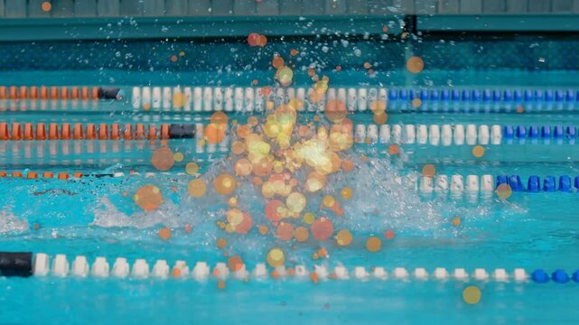 Male swimmer lifting head, initiating stroke and splashing, bokeh overlay obscuring and marking lap