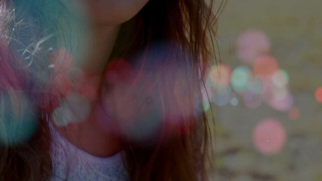 Camera rising and focusing up, female teen holding acoustic guitar smiling, revealing lace headband