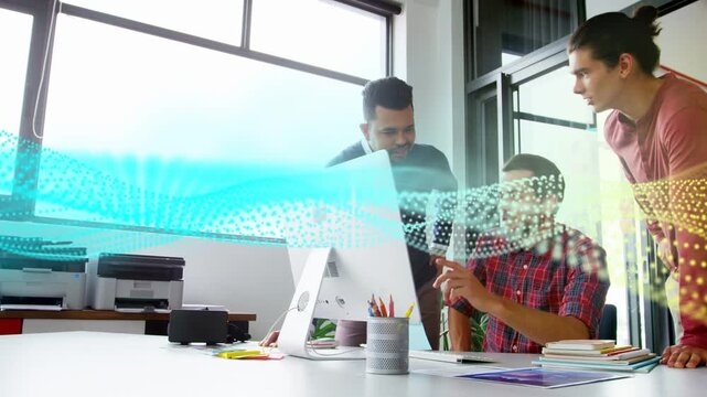 Seated man pointing initiating transparent data ribbon while team leaning and analyzing tech data