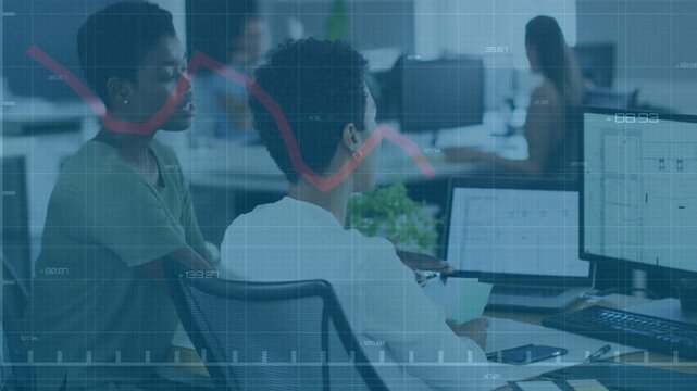 Midcareer woman and peer leaning, pointing at monitor sweeping red chart overlay for business check