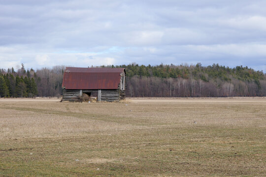 An old wooden barn in a field
