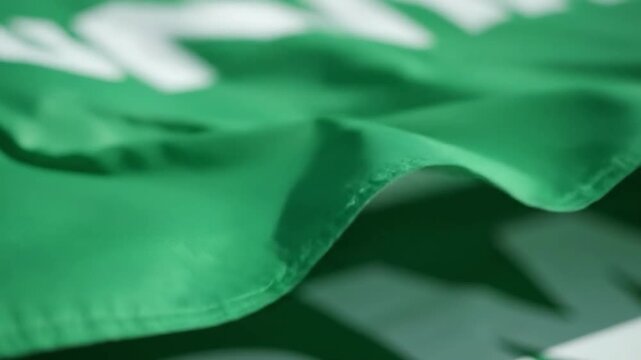 Close-up of a vibrant green fabric with stitched edge, perfect for background or texture use.