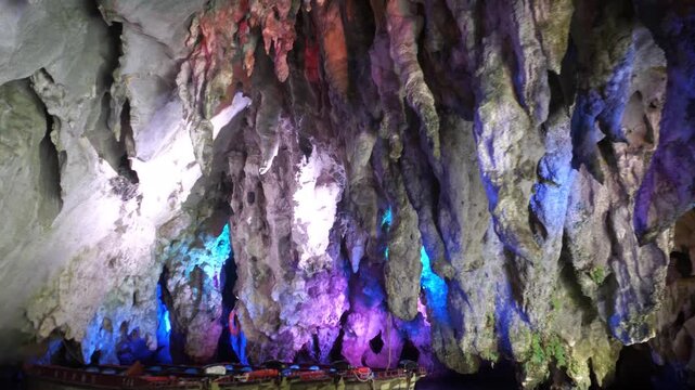 This video shows a stalactite cave with colorful lighting, located in China