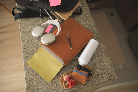 Overhead view of study area with student accessories, notebook, headphones, and bag