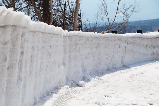 雪に覆われた道と雪壁（冬の北海道の風景）