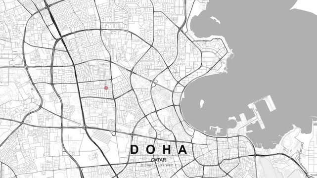 City map of Doha, Qatar, featuring curved coastline, major road connections and a red location pin highlighting a point within the urban grid.