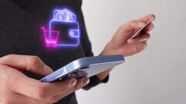 Paying for purchases with a wallet. Businesswoman holding a bank card while holding a smartphone with a virtual wallet icon and shopping cart.