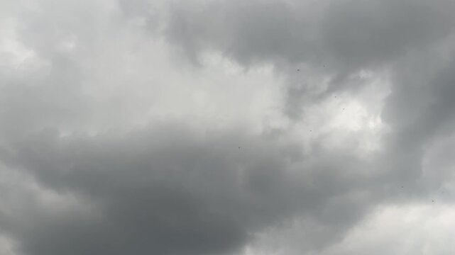 The dark sky with heavy clouds converging and a violent storm before the rain.Bad or moody weather sky and environment. carbon dioxide emissions, greenhouse effect, global warming, climate change.