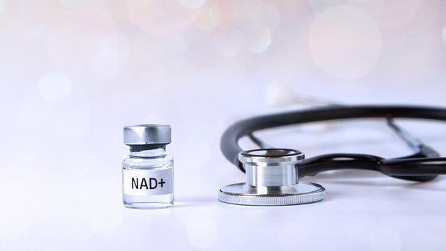 Medical vial labeled NAD Plus beside stethoscope representing hopeful longevity treatment concept for modern healthcare and wellness