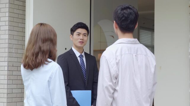 Welcoming new homeowners house for sale, smiling salesperson real estate realtor lead couple into new apartment tour, discussing contract terms, while holding expertly crafted floor plan for reference