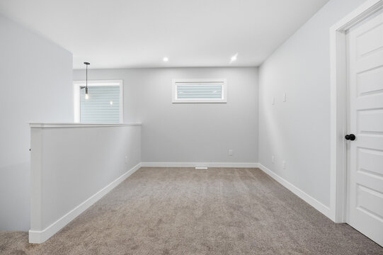 Empty room with white walls and carpeted floor