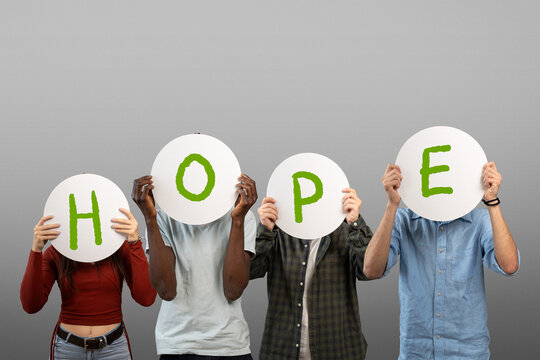 Diverse people holding word hope on round signs covering faces