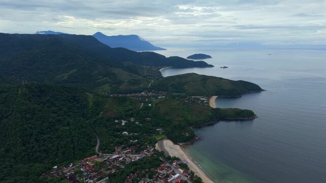 Maresias, Praia de Pa&uacute;ba, Praia do Santiago, and Toque Toque in S&atilde;o Sebasti&atilde;o S&atilde;o Paulo Brazil along Atlantic Ocean with Serra do Mar forested slopes in South America setting, drone high wide glide