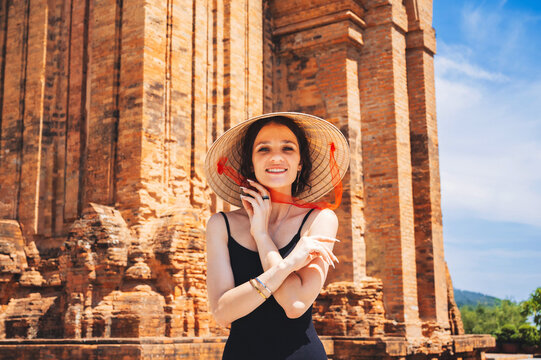 A female tourist in a traditional Non La hat at the Towers of Po Nagar Cham. Vietnam.