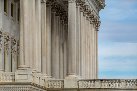 Columns stone repetition symmetry perspective. Columns marble architectural pattern. Columns decorative capitals carved detail. Columns neoclassical heritage exterior.