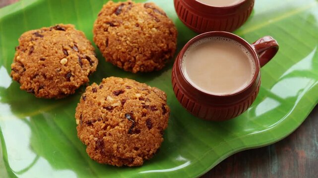 Parippu Vada or Paruppu Vadai made with toor dal. Kerala fried snacks savory food on banana leaf on dark black background. Kerala tea time food fried in coconut oil. Top view of South Indian snacks.