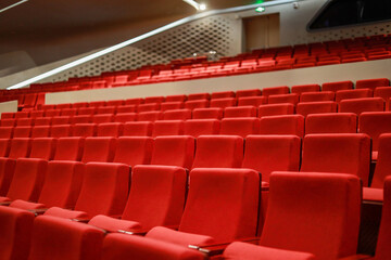 Fototapeta premium Red empty seats in the theater auditorium
