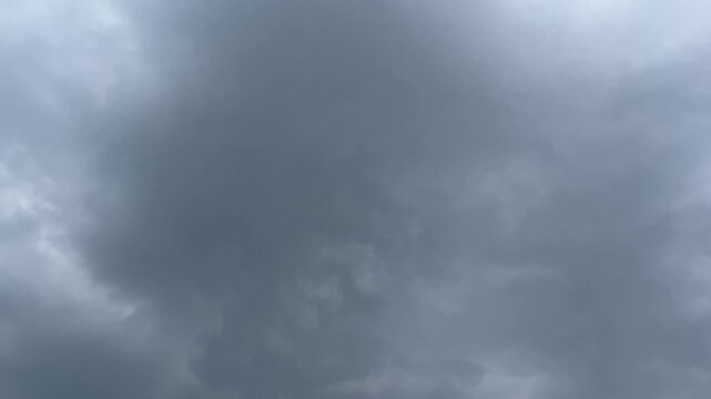 The dark sky with heavy clouds converging and a violent storm before the rain. Bad or moody weather sky and environment. carbon dioxide emissions, greenhouse effect, global warming, climate change. 