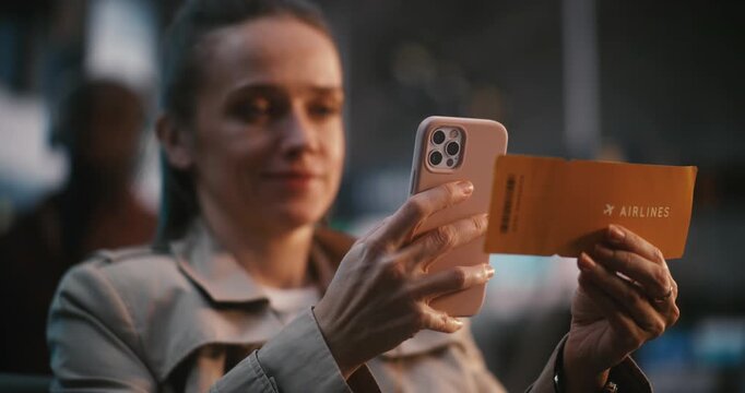 Close Up of Essential Tools of Modern Voyager. Smartphone in Pink Case and Bright Yellow Airline Ticket. Concept of Seamless Integration Technology Into Passenger Experience at Busy International Hub.