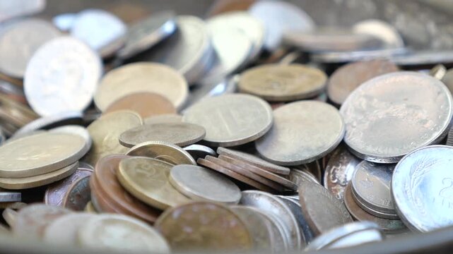 Collecting coins from different countries in a bowl