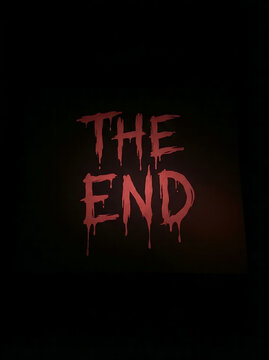 The End" text in a dark, spooky, and dripping red font, reminiscent of horror movies, signifying closure or a conclusion in a dramatic fashion