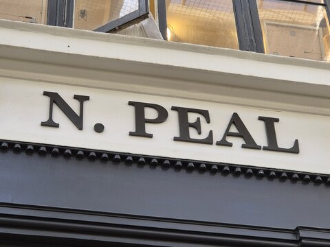 London UK 04.07.2025 N Peal luxury cashmere brand storefront sign on elegant facade with classic serif lettering highlighting premium fashion retail identity in stylish urban shopping district