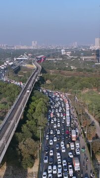 Vertical Aerial View of Delhi Metro and Traffic at Kalindi Kunj Bridge India