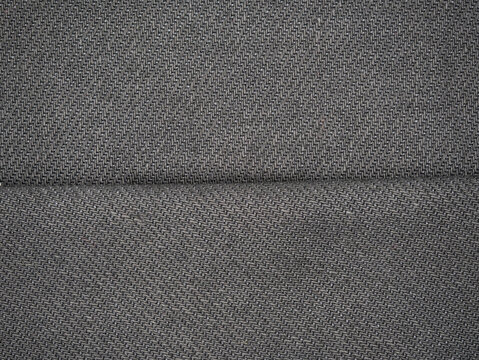 Close-up of gray textured fabric with diagonal weave pattern, suitable as background or upholstery textile.