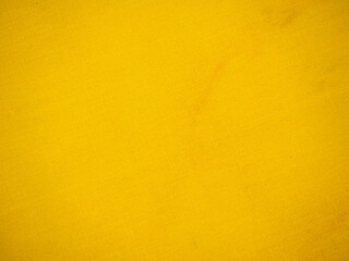 Fototapeta premium Close-up of bright yellow textured fabric or paper background with subtle weave pattern, abstract monochrome surface for design templates and copy space.