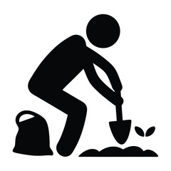 Fototapeta premium Silhouette of a person gardening with a shovel and bag of soil