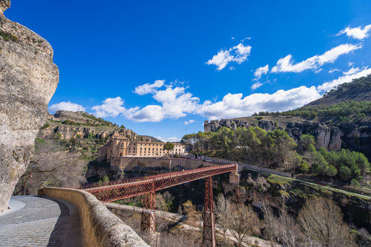 A scenic view of the historic San Pablo Bridge spanning the Huecar Gorge, connecting the old town of Cuenca with the San Pablo Convent in Spain.