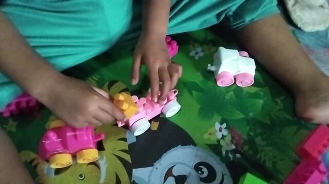 Close-up of a child playing puzzle on a colorful playmat, focusing on learning, creativity, and early childhood development