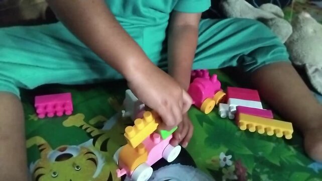 Close-up of a child playing puzzle on a colorful playmat, focusing on learning, creativity, and early childhood development