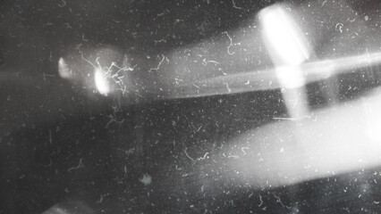 Obraz premium Old film texture with scratches, noise and light leaks. Realistic transparent overlay film texture in black-white, dust and grain. Distressed retro movie or photo negative effect of cinema nostalgia