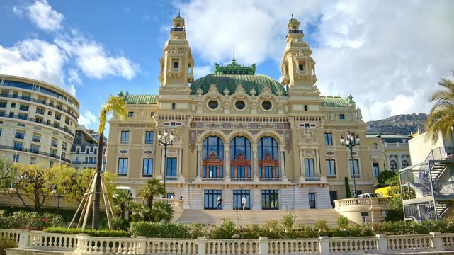 Monte Carlo casino exterior facade with architecture detail and garden on sunny day in Monaco city.