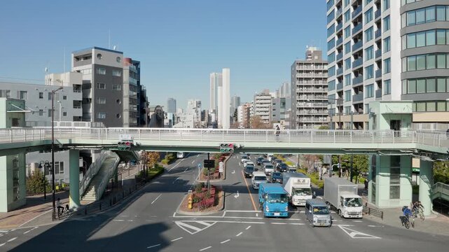 Tokyo Scene : Pedestrian Overpass With Elevators, Famous as a Setting for Stories, Spans an Intersection of City Arteries. The Traffic Light Changes   |  Tomigaya Footbridge, Shibuya, Tokyo, Japan