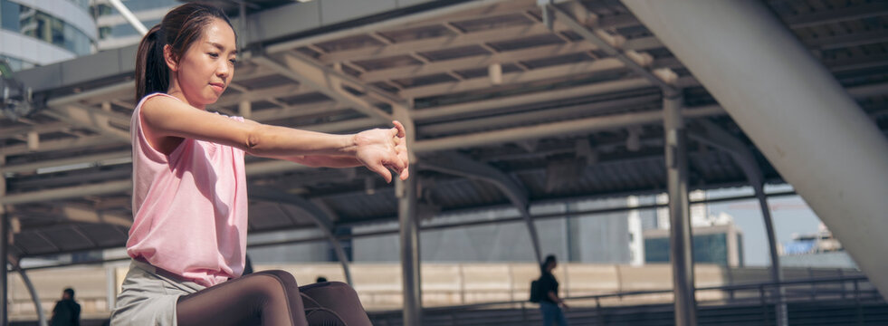 Banner Sport Fitness caucasian Woman stretching body exercise in modern city wear sportswear outside. Banner Young woman workout outdoor exercising outside. Healthy wellness with copy space